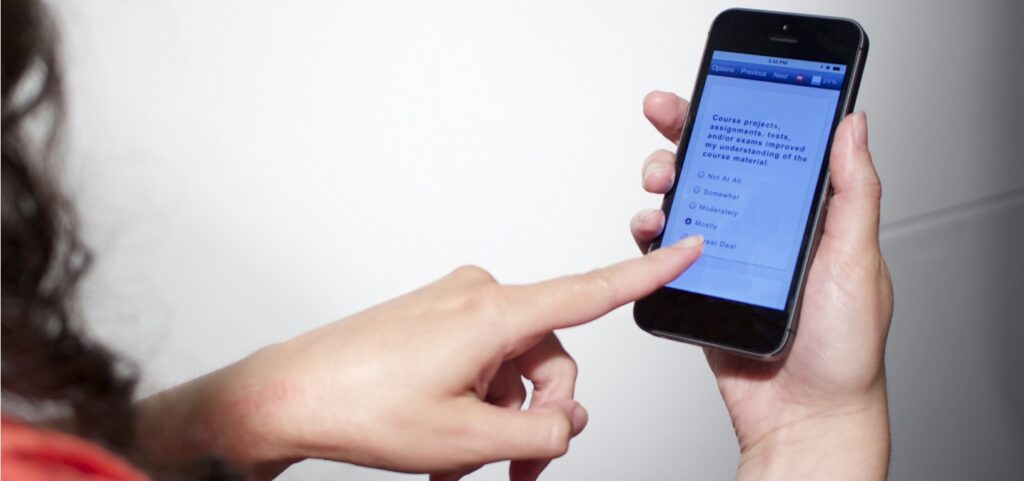 Finger pointing to mobile phone