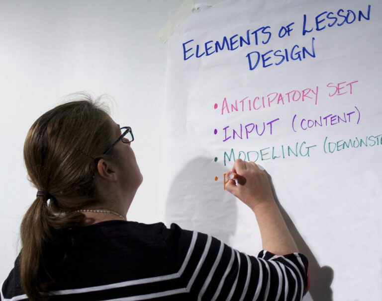 woman writing on flip chart