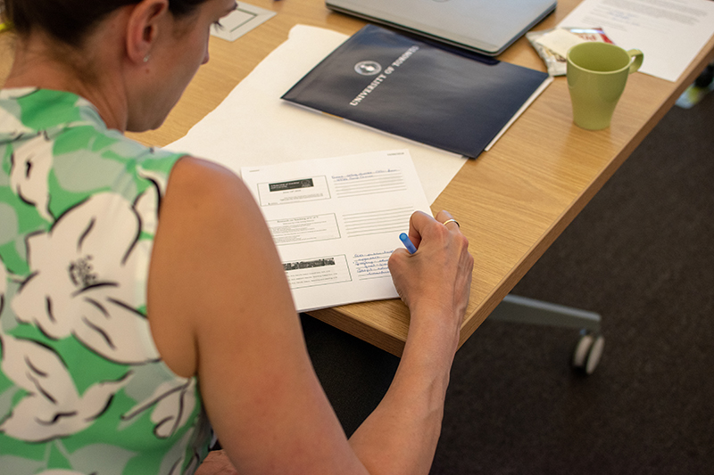 Image of woman writing at a table