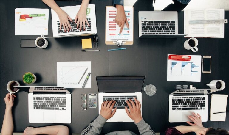 overhead view of people working on laptops